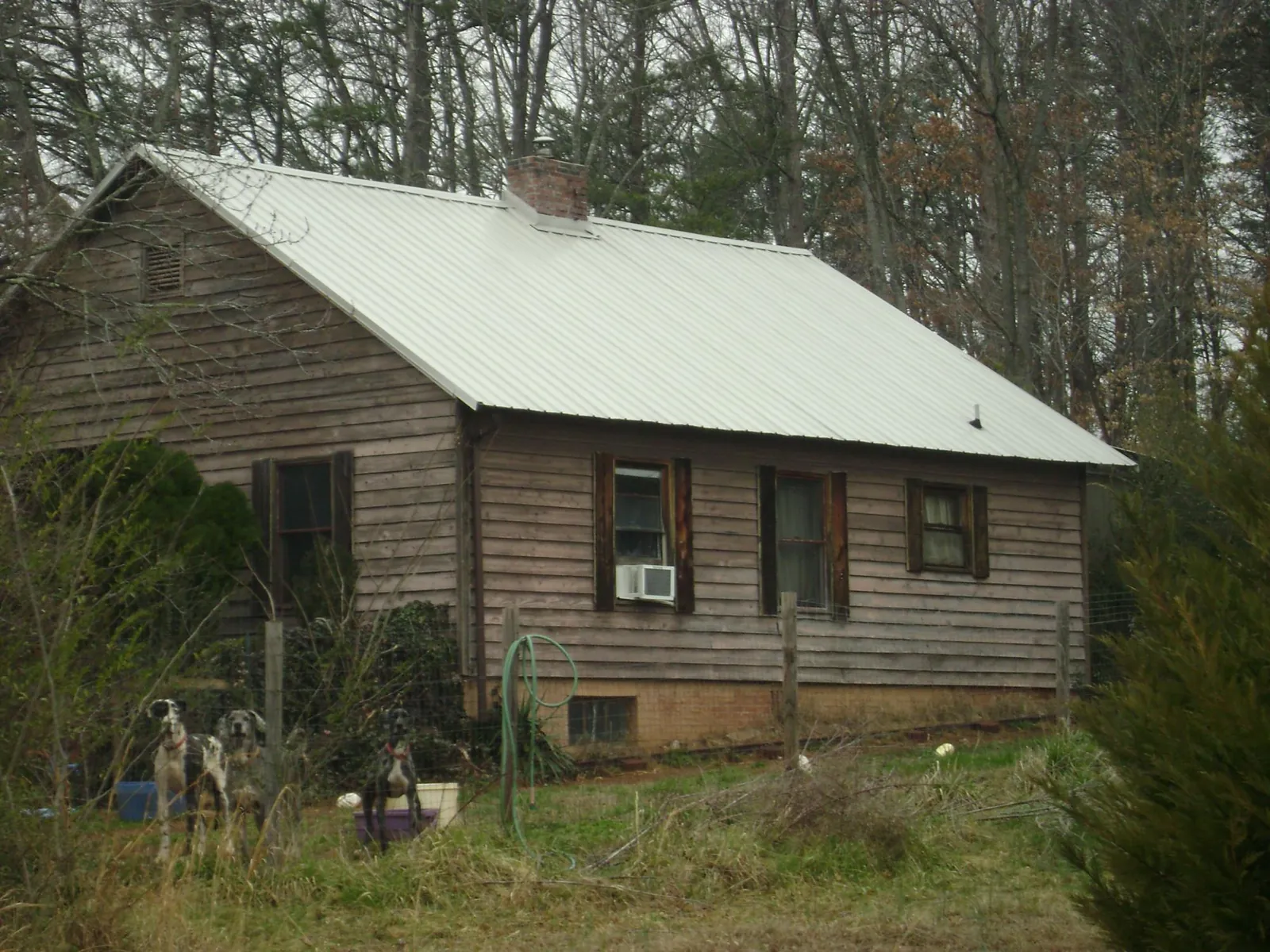 White metal roof on an old wood sided farmhouse, from a Metal Roof Installation job in Gambell